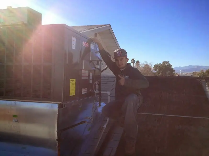 HVAC technician performing AC Tune-Up on a rooftop unit in El Dorado Hills